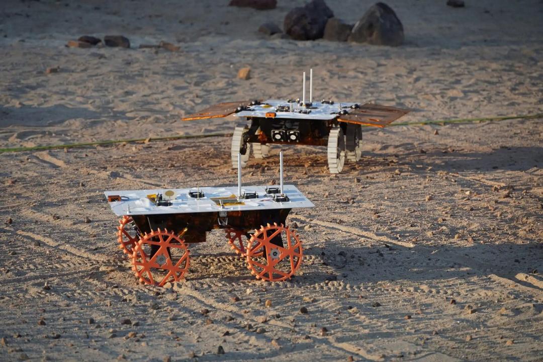 A Group of Three Small Rovers Destined for the Moon is Prepared to Commence Their Mission. A Group of Three Small Rovers Destined for the Moon is Prepared to Commence Their Mission.